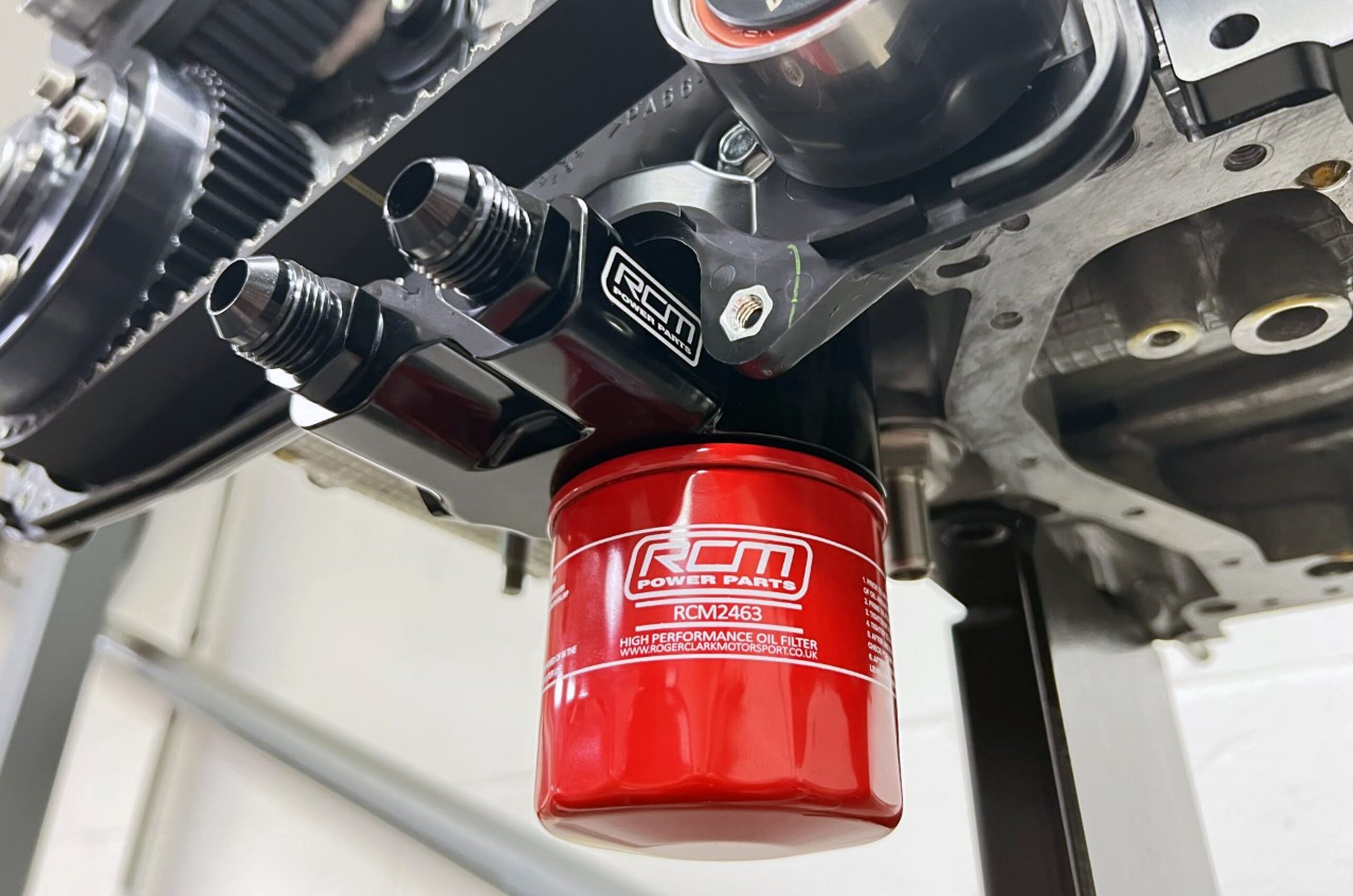 RCM3334-withfilterfittedtest.jpg RCM3334 oil sandwich plate installed on an engine, showing oil filter position